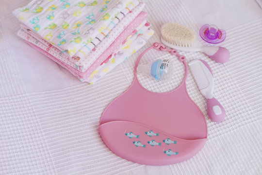 Pink Plastic Baby Bib ,Hairbrush and Diapers