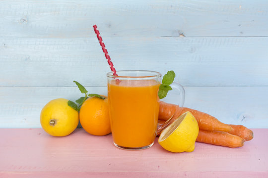 orange smoothie with carrots lemon and  orange . Healthy life concept.