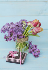 gift box and tulip  flowers in a vase 