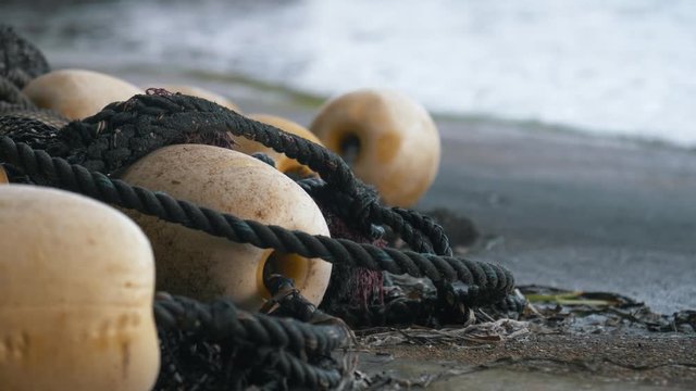 Closeup shot of a used fishing net with the water in the background.
