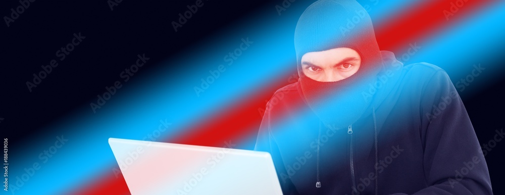 Poster hacker in balaclava hacking a laptop