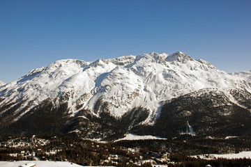 A view of a town and snow covered mountain in the alps switzerland