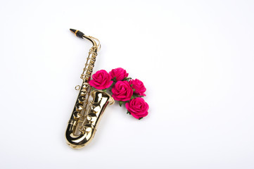 Jazz Day. Saxophone with flowers. Flat lay, top view