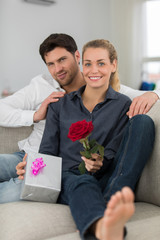 Valentine's day. Young beautiful woman receives a from her handsome boyfriend