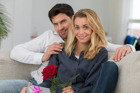 Valentine's day. Young beautiful woman receives a from her handsome boyfriend
