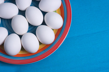 Easter eggs on colorful plate and blue background