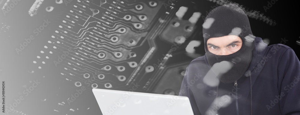 Poster composite image of hacker in balaclava hacking a laptop