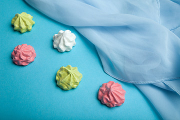 A festive meringue dessert on a blue background.