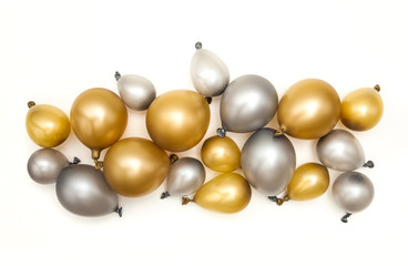 Gold and silver party celebration balloons on a plain background