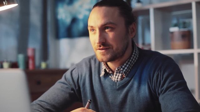 Young designer, businessman, worker gets the new idea. Highly motivated, inspired man in a cozy modern office. Close up view