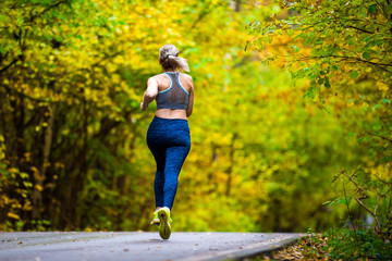 Woman running in the autumn park