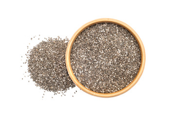 Chia seeds in a wooden bowl with a small pile next to it seen from above isolated on white background