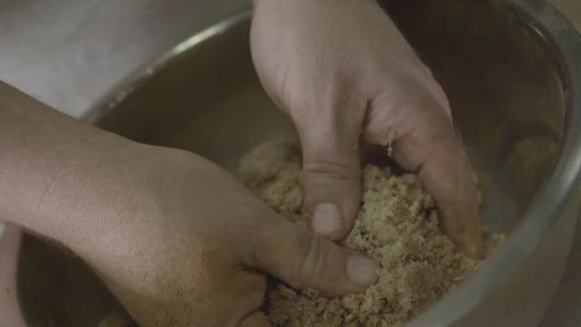 Chef mixes cinnamon sugar in bowl, close up
