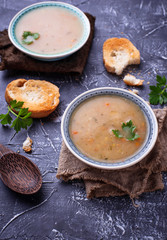 Healthy vegetarian peas soup on concrete background