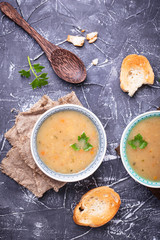 Healthy vegetarian peas soup on concrete background