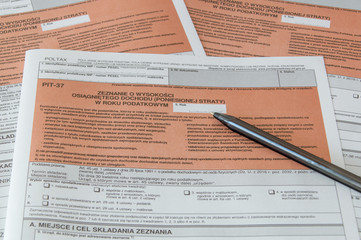 Polish tax form PIT-37 with pen.