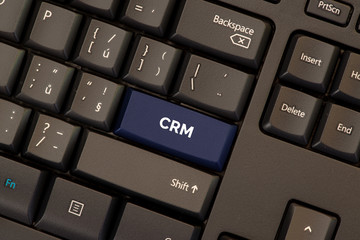 Customer relationship management concept on blue button keyboard CRM