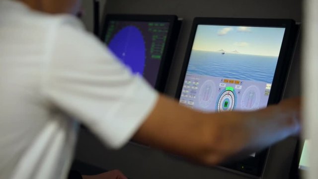 Naval school student studying control of the ship on simulation program to practice navigation