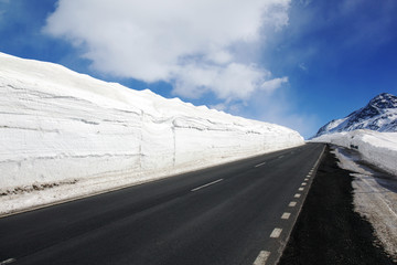 An empty highway and snow covered landscape next to it in St Moritz Switzerland in the alps