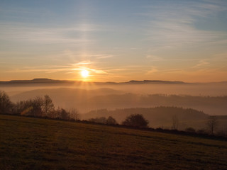 View of the setting sun in the Sudety Mountains 
