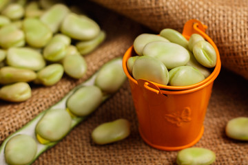 fresh broad beans on a rustic background