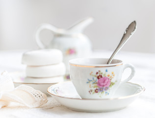 Luxury porcelain tea set with a cup, teapot, sugar bowl on white tablecloth