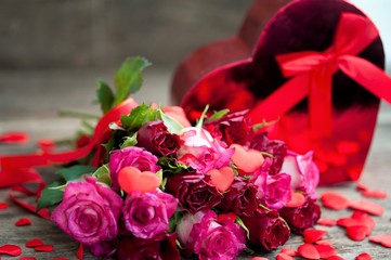 beautiful bouquet of roses and a gift