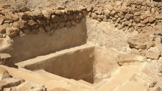 zoom in shot of a ritual bath at qumran near the dead sea, israel