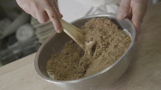 Close up, baker mixes cinnamon sugar in slow motion