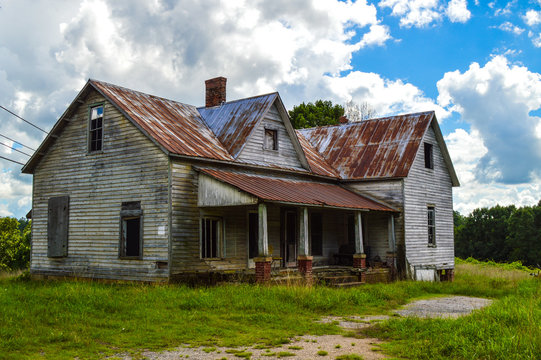 Old abandoned wooden house with rusted tin roof