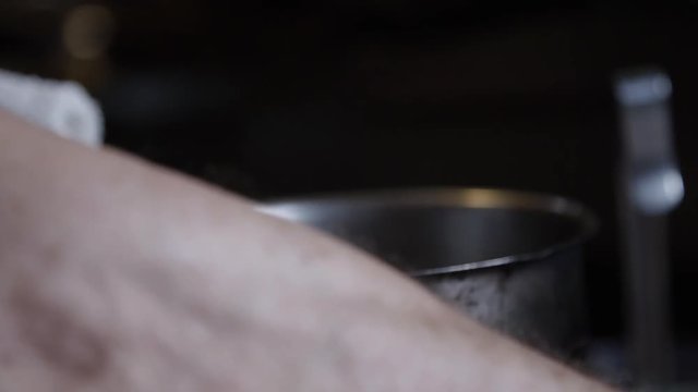 Slow motion, chef throws garlic into pot