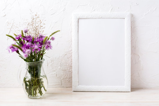 White frame mockup with burdock flowers in the jug