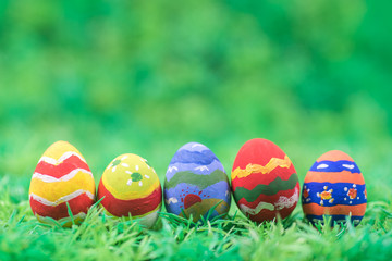 rows of easter eggs in grass field