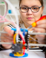 Teenager girl with 3d printe. education