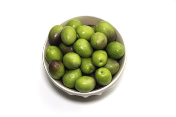 Plate of Green olives ready to eat in white background.