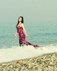 woman in pink  dress at the sea beach 