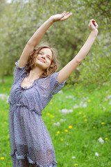 Obraz premium young woman in dress relaxing in garden 
