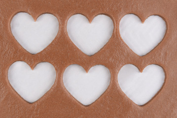 Six heart shapes cut out of dough