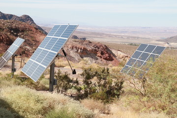solar panels in the desert amid rocks