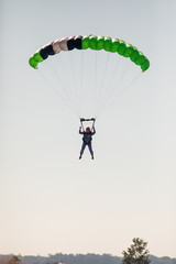 Skydiving with green parachute
