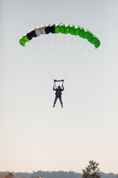 Skydiving with green parachute