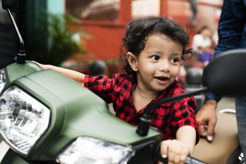 Young Indian boy riding the motorbike