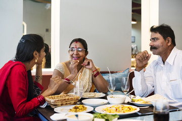 Fototapeta na wymiar Family having Indian food