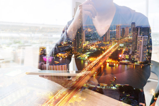 Double Exposure of Man or Male hold Digital Wireless Tablet with City Building