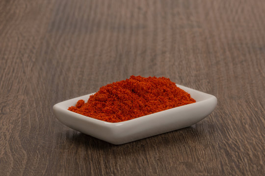 Bowl of ground red pepper spice in bowl