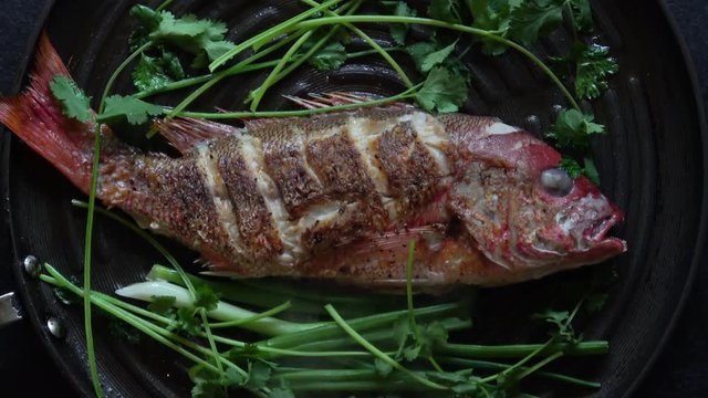 Grilled Whole Red Snapper with Ginger Soy Sauce and Garnish. Served hot in the Frying Pan. Zoom In.