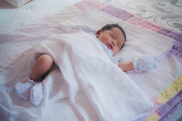 newborn baby girl falling in sleep after feeding
