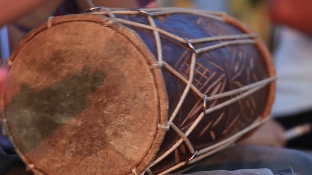 Man playing on a Bongo drum close up. Hand tapping a Bongo drum in close up. Drums hands, movement, rhythm. Goa state, Arambol beach. India