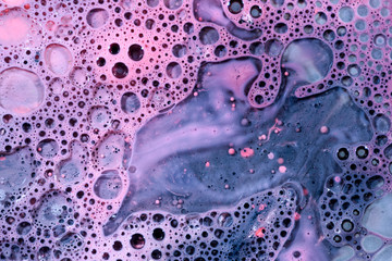 Toxic chemical acrylic oil droplets on water foam creating the idea of pollution concepts ideas and...