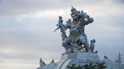 Statue of God fighting with monkeys in Pura Luhur Uluwatu, Bali. Monkey god sculpture at Pura Luhur Temple. Traditional Hindu temple, old hindu architecture, Bali Architecture, Ancient design. Travel